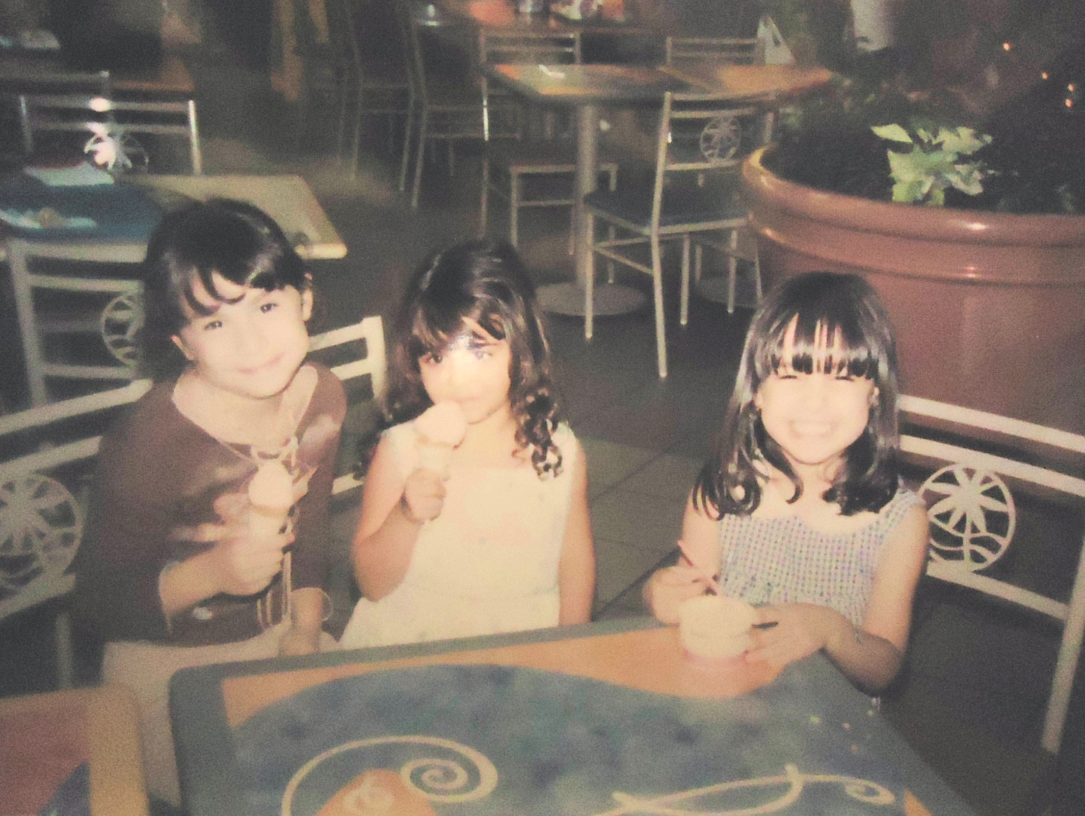 A photograph of the author as a young girl, eating ice cream with two other girls
